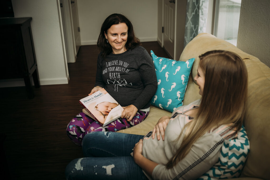 A midwife Yvonne Gray discussing a personalized birth plan with a couple.