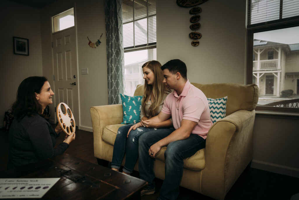 Midwife, Yvonne Gray, consulting with a family in the welcoming environment of their home.