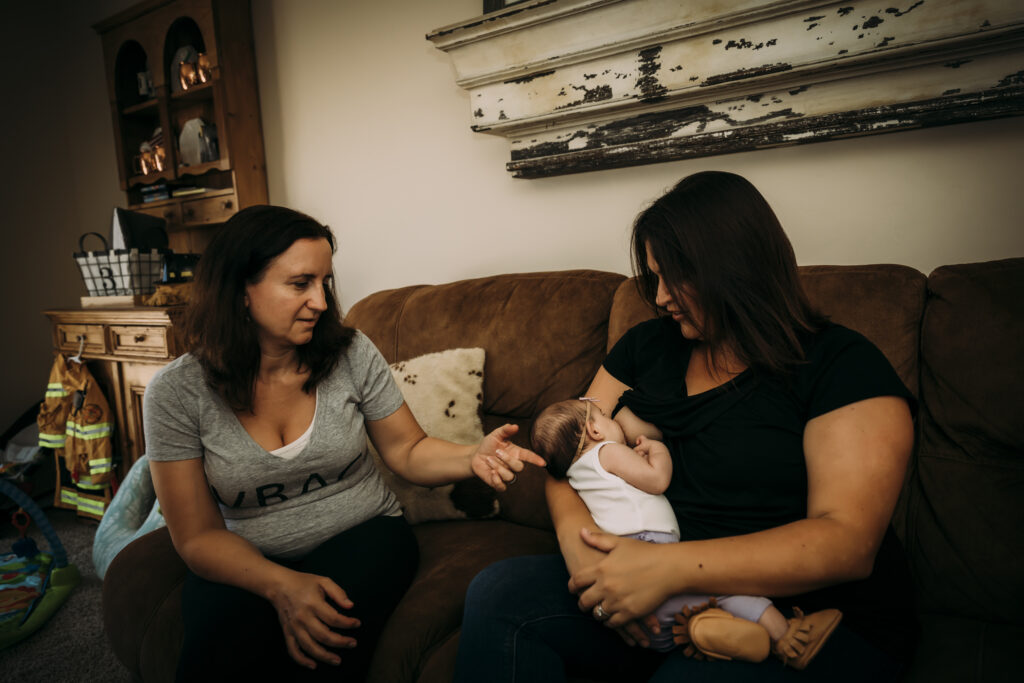 A mother consulting with lactation consultant and midwife Yvonne Gray to manage common breastfeeding challenges.