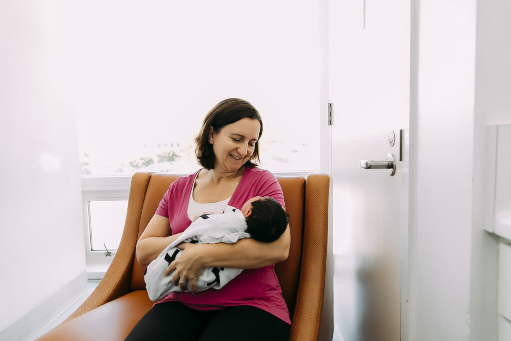 Yvonne Gray, midwife, providing personalized care to a baby after a home birth.